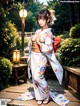 A woman in a kimono standing on a wooden walkway.