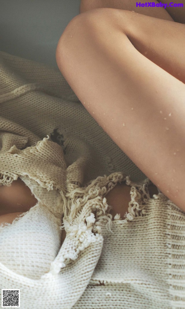 A close up of a woman's legs wrapped in a blanket.