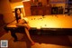 A woman sitting on top of a pool table.