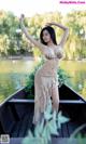 A woman in a bikini standing on a boat in the water.