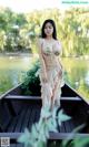 A woman in a bikini standing on a boat in the water.