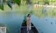 A woman sitting on a boat in the middle of a lake.