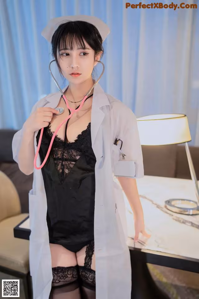 A woman dressed as a nurse holding a stethoscope.