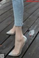 A close up of a person wearing a pair of silver shoes.