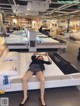 A woman laying on top of a bed in a store.